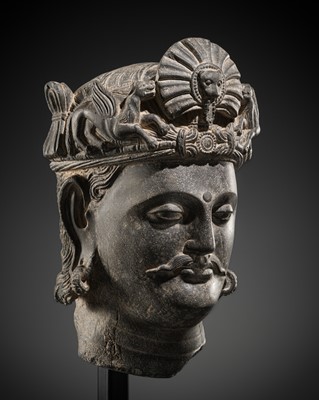 Lot 406 - A SUPERB GRAY SCHIST HEAD OF A BODHISATTVA WITH A ‘KIRTIMUKHA’ TURBAN CREST, ANCIENT REGION OF GANDHARA, 4TH-5TH CENTURY