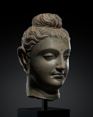 Lot 402 - A GRAY SCHIST HEAD OF BUDDHA, ANCIENT REGION OF GANDHARA, 2ND-3RD CENTURY