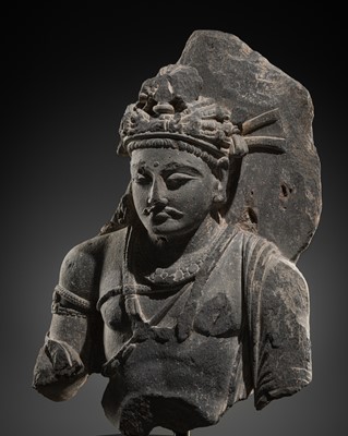 Lot 401 - A GRAY SCHIST BUST OF BODHISATTVA SHAKYAMUNI, ANCIENT REGION OF GANDHARA, 2ND-3RD CENTURY