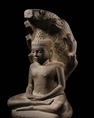 Lot 442 - A KHMER SANDSTONE FIGURE OF BUDDHA MUCHALINDA, ANGKOR PERIOD, BAYON STYLE, 13TH CENTURY