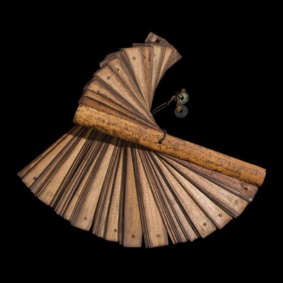 Lot 474 - A TAI BUDDHIST PALM-LEAF MANUSCRIPT BOUND BETWEEN TWO INSCRIBED WOODEN BOARDS