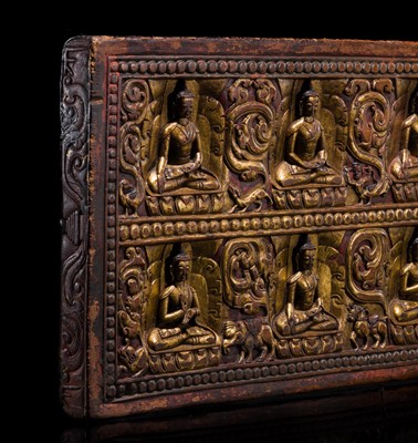 Lot 34 - A GILT LACQUERED WOOD MANUSCRIPT COVER WITH THE TEN BUDDHAS, 13TH CENTURY