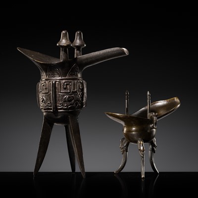 Lot 154 - A GROUP OF TWO INSCRIBED ARCHAISTIC BRONZE RITUAL VESSELS, JUE, QING DYNASTY