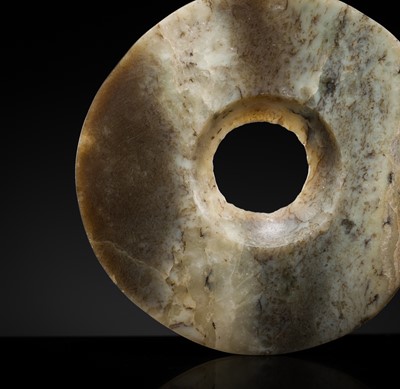 Lot 198 - A PALE GREEN AND BROWN JADE DISC, BI, NEOLITHIC PERIOD, QIJIA CULTURE