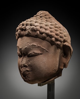 Lot 331 - A LARGE RED SANDSTONE HEAD OF A JAIN TIRTHANKARA, INDIA, 11TH-12TH CENTURY