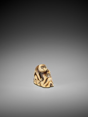 Lot 421 - A STAG ANTLER NETSUKE OF A MONKEY ON A ROCK