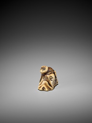 Lot 421 - A STAG ANTLER NETSUKE OF A MONKEY ON A ROCK
