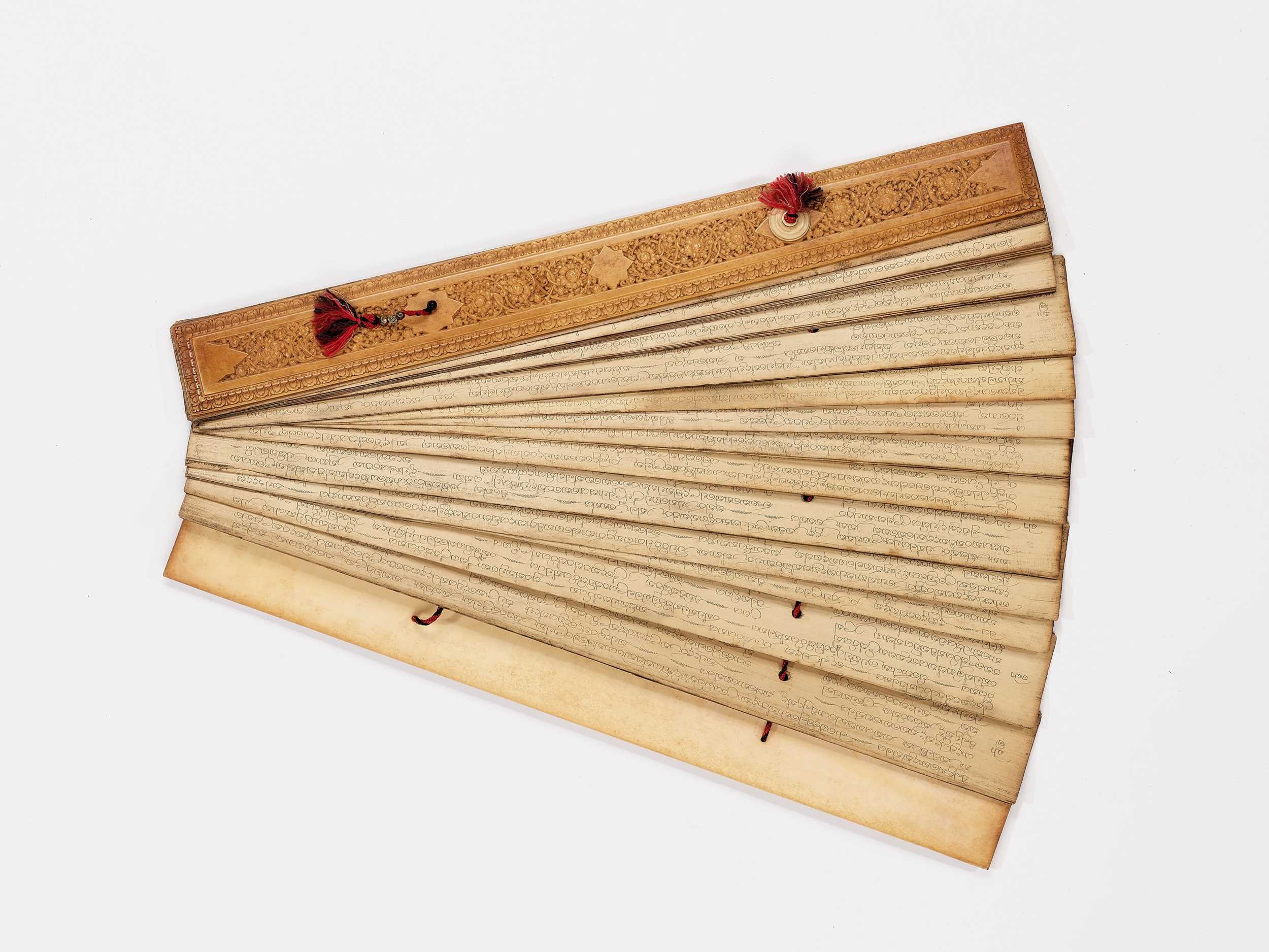 Lot 1325 - A CEYLONESE PALM LEAF MANUSCRIPT WITH IVORY COVERS, 19TH CENTURY