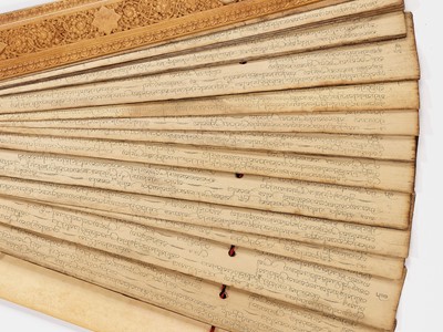 Lot 1325 - A CEYLONESE PALM LEAF MANUSCRIPT WITH IVORY COVERS, 19TH CENTURY