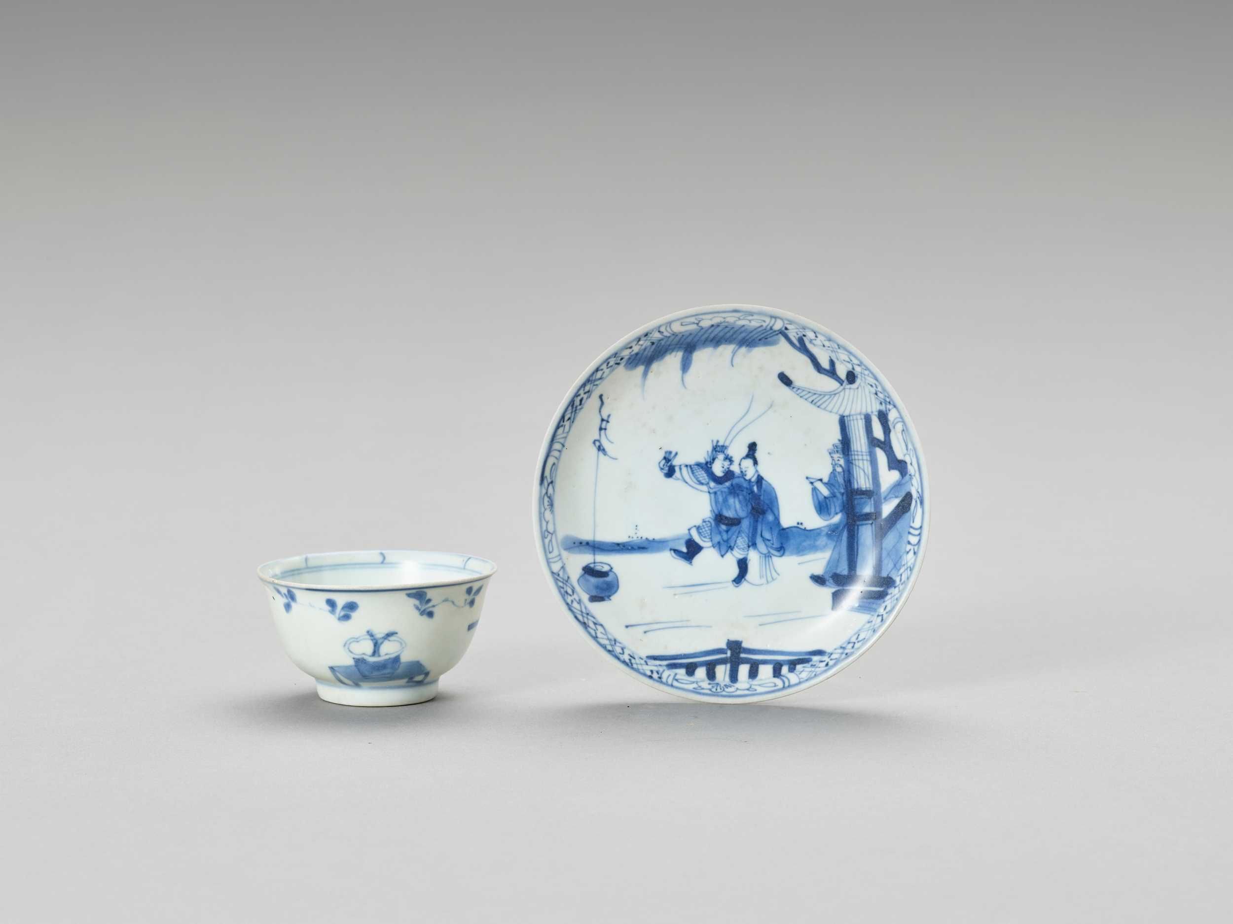 Lot 627 - A BLUE AND WHITE PORCELAIN CUP AND SAUCER, MING