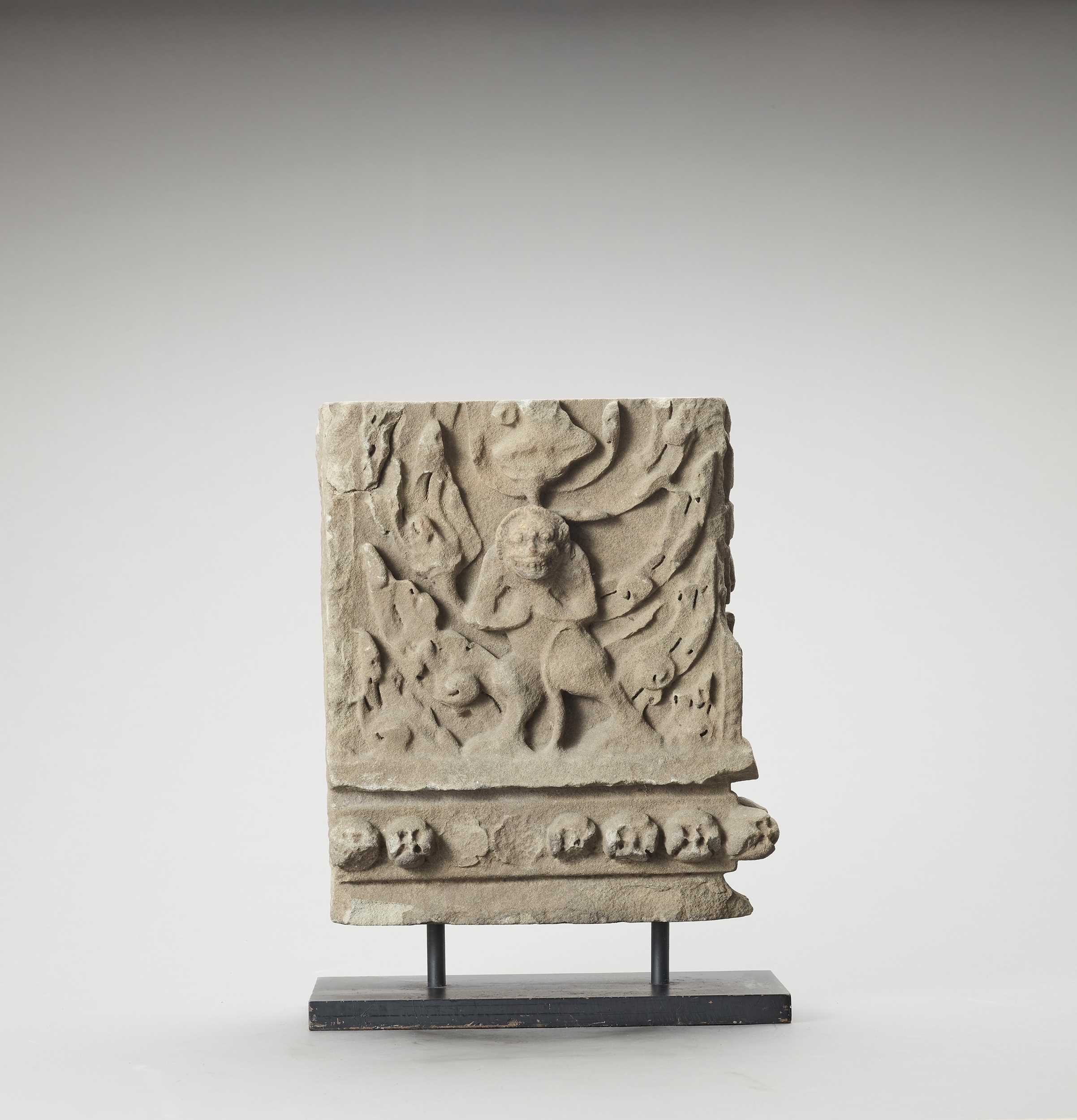 Lot 1179 - A KHMER SANDSTONE BAYON STYLE BAS-RELIEF WITH LION, ANGKOR PERIOD
