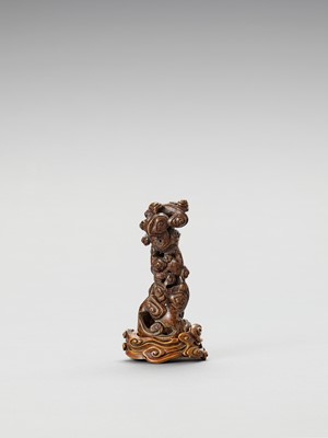 Lot 860 - A CARVED AGARWOOD ‘LINGZHI CLOUDS’ JOSS-STICK HOLDER WITH BOXWOOD STAND, QING
