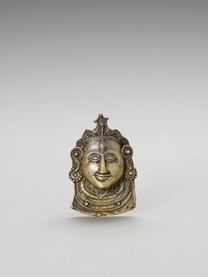 Lot 1253 - AN INDIAN BRASS MOHRA OF SHIVA
