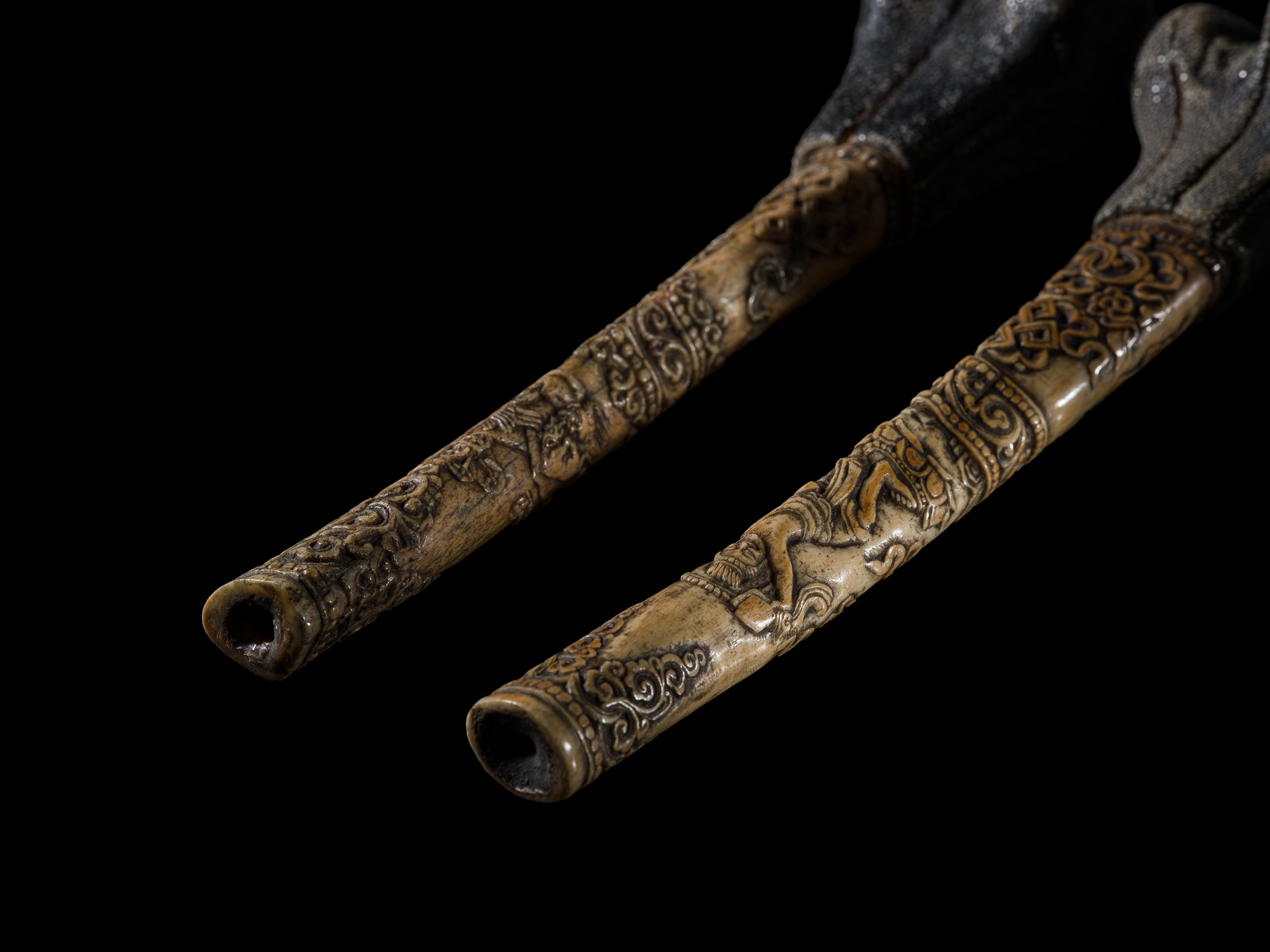 Lot 254 - A PAIR OF CARVED LEG BONE TRUMPETS, KANGLING,