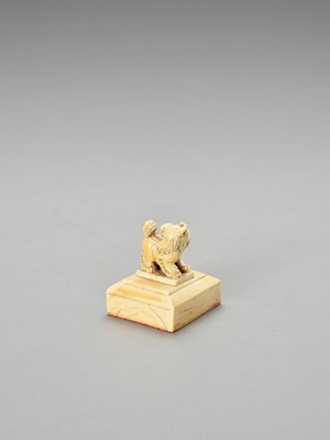Lot 740 - A CARVED IVORY ‘BUDDHIST LION’ SEAL, LATE QING