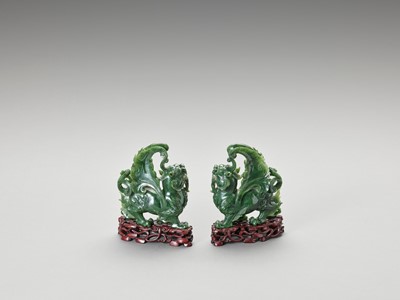 Lot 779 - A PAIR OF SPINACH-GREEN JADE FIGURES OF QILIN, LATE QING TO REPUBLIC