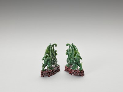 Lot 779 - A PAIR OF SPINACH-GREEN JADE FIGURES OF QILIN, LATE QING TO REPUBLIC