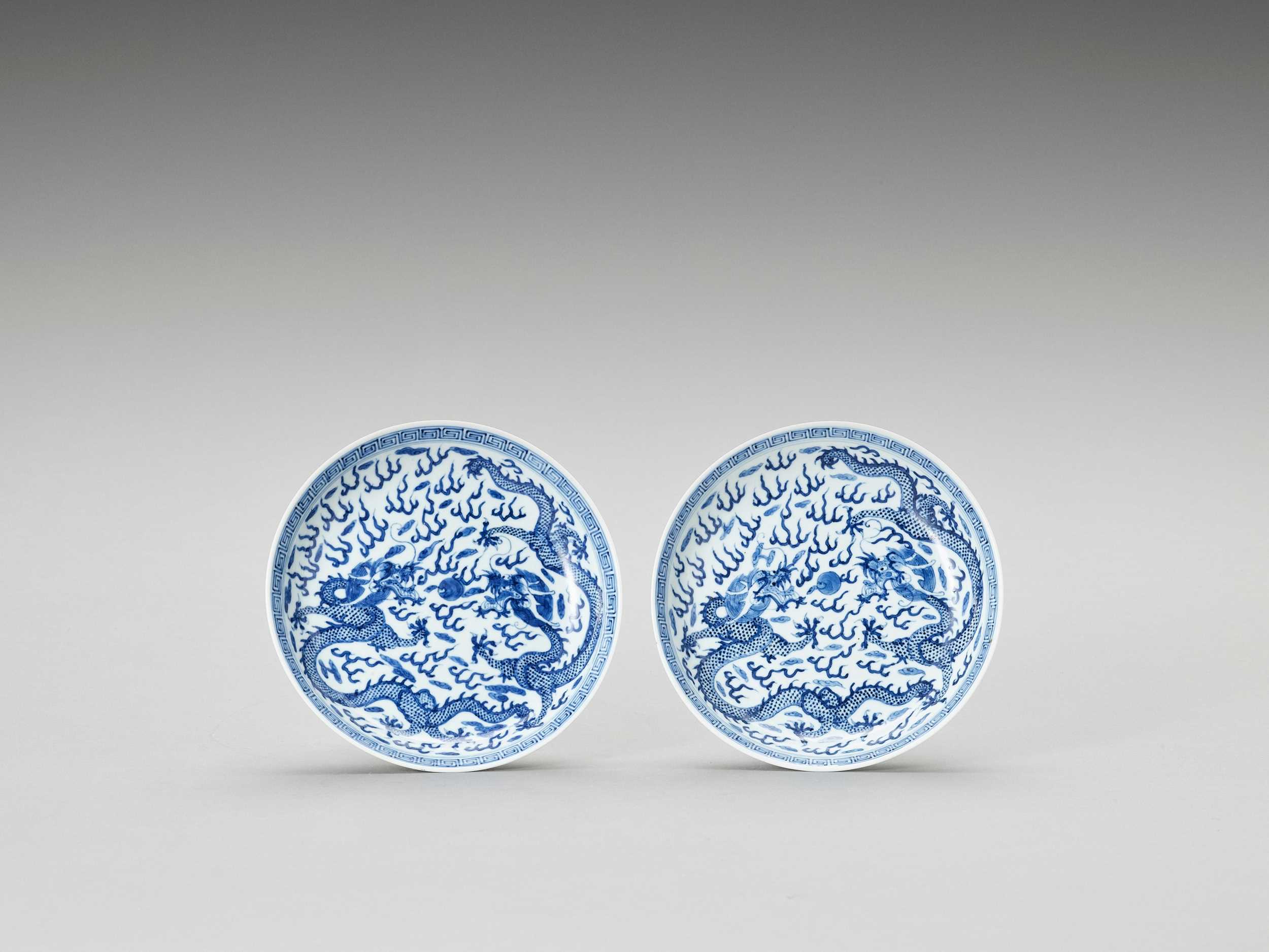 Lot 701 - A PAIR OF BLUE AND WHITE PORCELAIN ‘DRAGONS’ DISHES, LATE QING