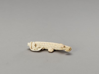 Lot 112 - A STAINED IVORY OKIMONO OF A CORN COB WITH INSECTS