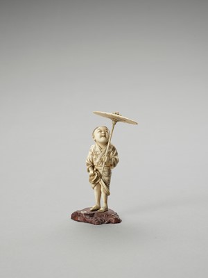 Lot 158 - AN IVORY OKIMONO OF A BOY WITH PARASOL