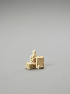 Lot 142 - AN IVORY OKIMONO OF A MAN WRITING IN A BOOK