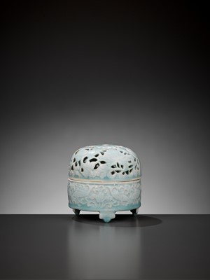 Lot 185 - A MOLDED QINGBAI ‘LOTUS POND’ TRIPOD CENSER AND OPENWORK COVER, SONG DYNASTY