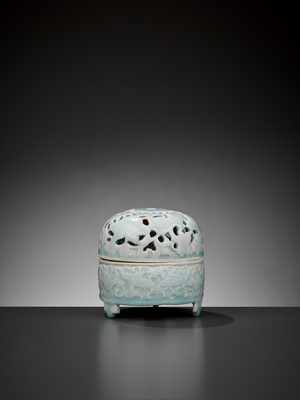 Lot 185 - A MOLDED QINGBAI ‘LOTUS POND’ TRIPOD CENSER AND OPENWORK COVER, SONG DYNASTY