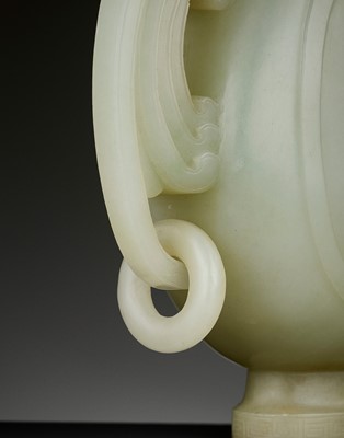 Lot 101 - A PALE CELADON JADE ‘PHOENIX’ EWER AND COVER, QING DYNASTY