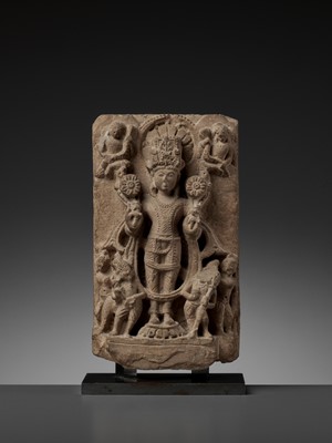 Lot 752 - AN INDIAN SANDSTONE STELE OF SURYA, MEDIEVAL PERIOD