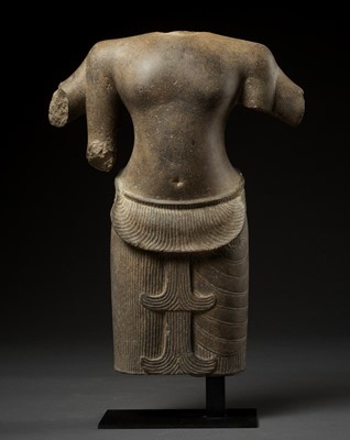 Lot 698 - A SANDSTONE TORSO OF A FOUR-ARMED DEITY, ANGKOR PERIOD