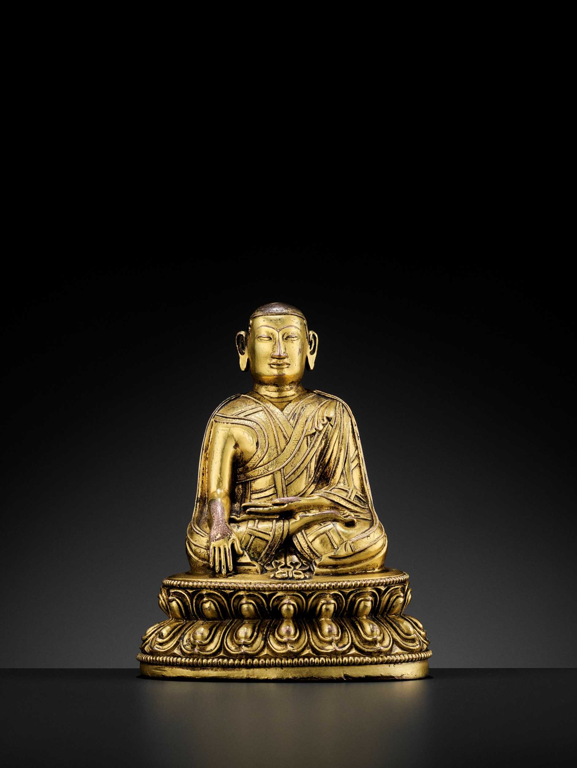 Lot 486 - A TIBETAN GILT-BRONZE FIGURE OF A LAMA, 13TH-