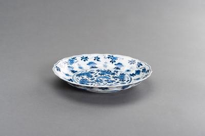 Lot 342 - A BLUE AND WHITE PORCELAIN ‘FLORAL’ LOBED AND BARBED-RIM BOWL, KANGXI MARK AND PERIOD