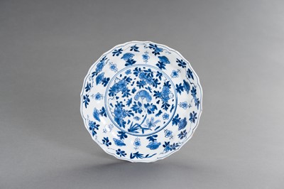 Lot 342 - A BLUE AND WHITE PORCELAIN ‘FLORAL’ LOBED AND BARBED-RIM BOWL, KANGXI MARK AND PERIOD
