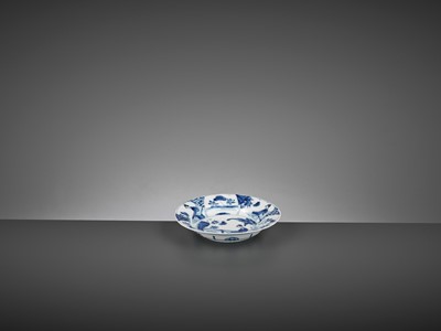 Lot 241 - A BLUE AND WHITE ‘LADY IN A GARDEN’ LOBED DISH, KANGXI MARK AND PERIOD