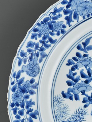 Lot 322 - A LARGE BLUE AND WHITE ‘PRUNUS AND LINGBI’ LOBED DISH, KANGXI MARK AND PERIOD