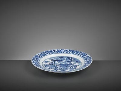 Lot 322 - A LARGE BLUE AND WHITE ‘PRUNUS AND LINGBI’ LOBED DISH, KANGXI MARK AND PERIOD