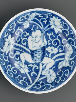 Lot 323 - A NEAR-PAIR OF BLUE AND WHITE ‘LOTUS BOY’ DISHES, KANGXI PERIOD