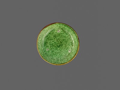 Lot 165 - A MOLDED GREEN AND AMBER-GLAZED POTTERY DISH, LIAO DYNASTY