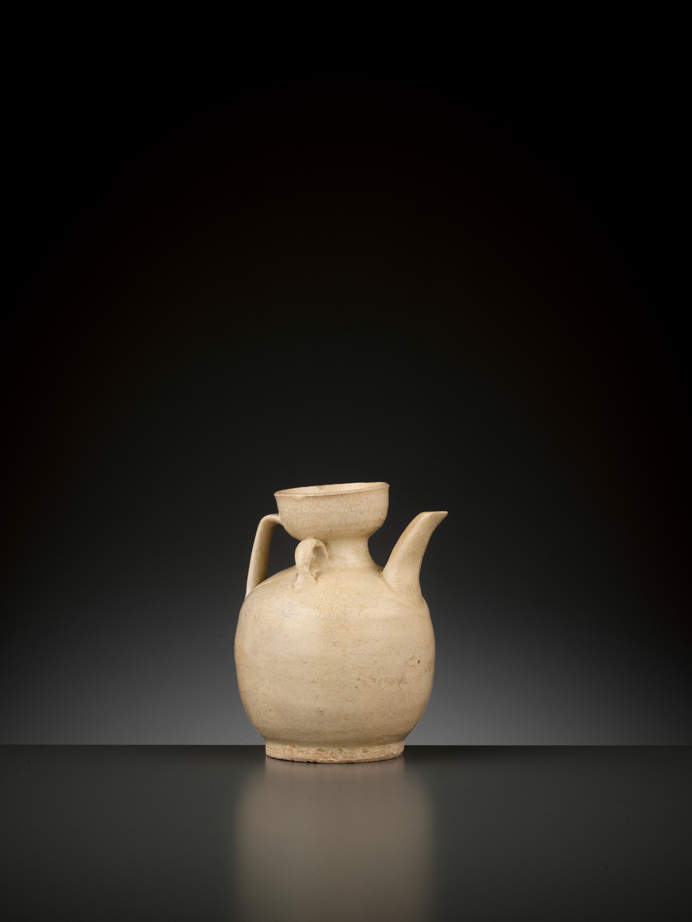 Lot 169 - AN IVORY-GLAZED EWER, FIVE DYNASTIES TO SONG