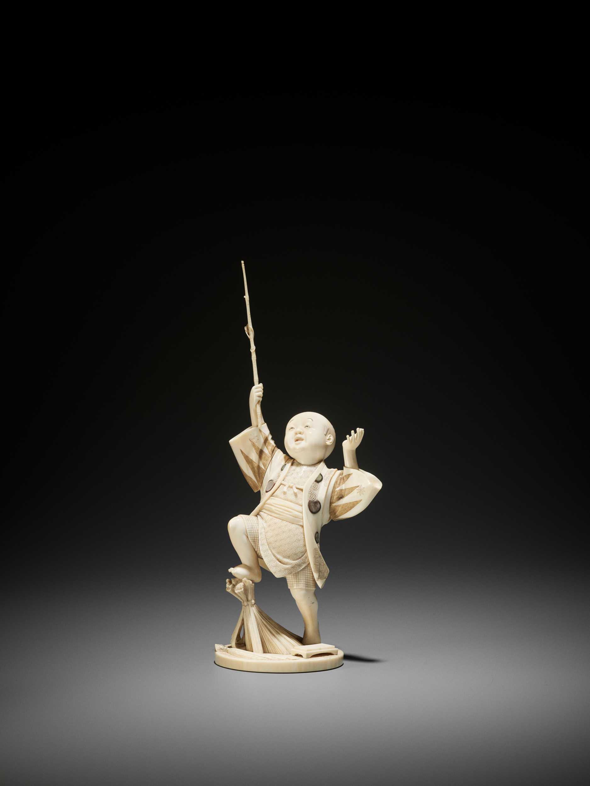 Lot 160 - GYOKUSUI: AN IVORY OKIMONO OF A BOY CATCHING A DRAGONFLY