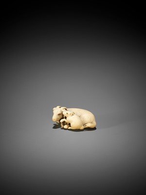 Lot 292 - TOMOKAZU: AN IVORY NETSUKE OF A GOAT WITH YOUNG
