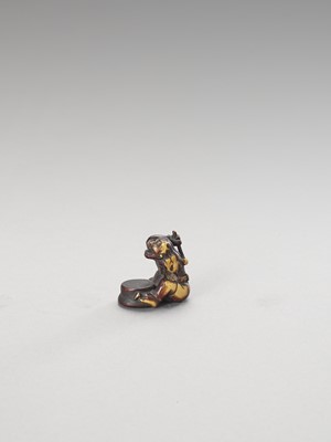 Lot 285 - A STAINED IVORY NETSUKE OF A CONVERTED ONI