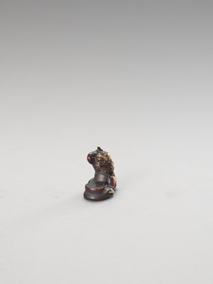 Lot 285 - A STAINED IVORY NETSUKE OF A CONVERTED ONI