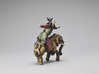 Lot 719 - A GLAZED TERRACOTTA FIGURE OF A DIGNITARY RIDING AN ELEPHANT, MID-QING