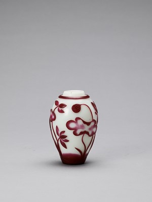 Lot 921 - A RUBY RED OVERLAY PEKING GLASS ‘LOTUS’ VASE, QING