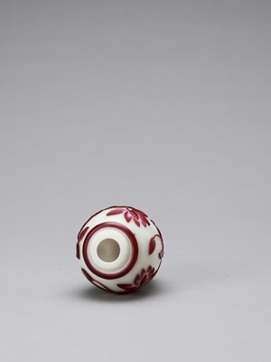 Lot 921 - A RUBY RED OVERLAY PEKING GLASS ‘LOTUS’ VASE, QING