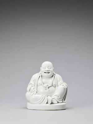 Lot 848 - A WHITE GLAZED DEHUA PORCELAIN FIGURE OF BUDAI, QING