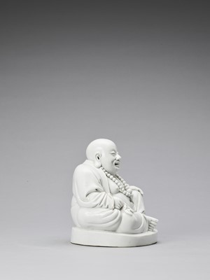 Lot 848 - A WHITE GLAZED DEHUA PORCELAIN FIGURE OF BUDAI, QING