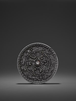 Lot 511 - A BRONZE 'LION AND GRAPEVINE' CIRCULAR MIRROR, TANG DYNASTY
