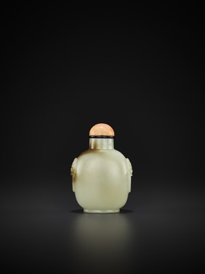 Lot 803 - A CELADON AND RUSSET JADE ‘LION MASK’ SNUFF BOTTLE, MID-QING